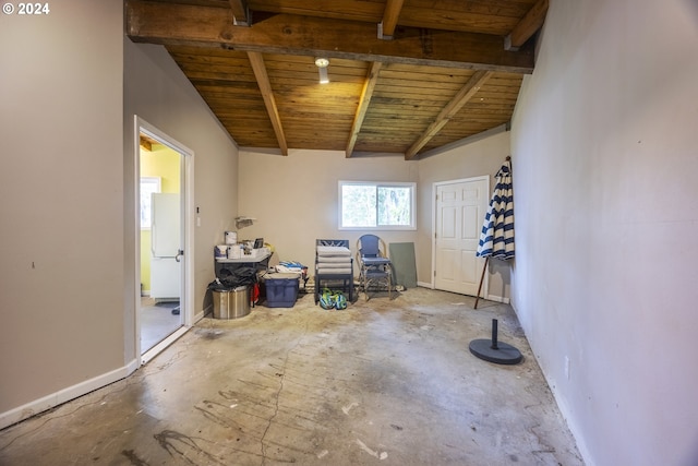 misc room featuring beamed ceiling, concrete floors, and wooden ceiling