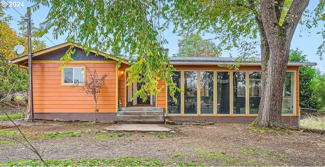 view of front of home featuring a sunroom