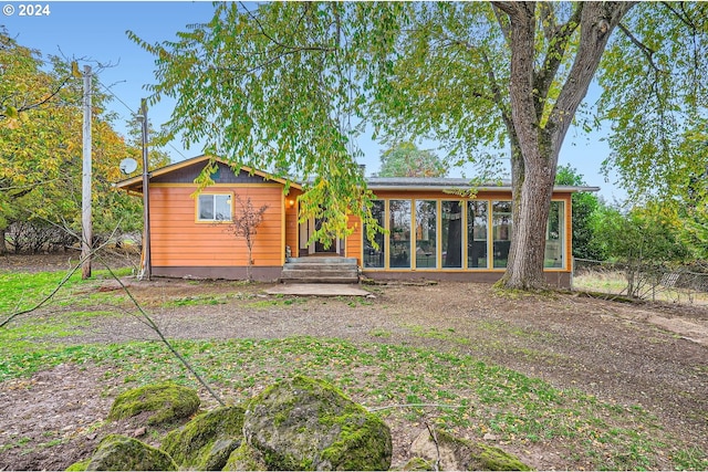 back of house with a sunroom