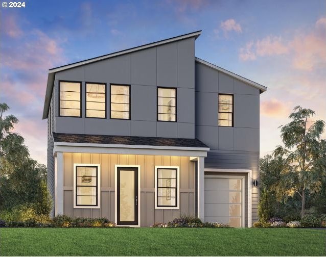 contemporary home featuring a garage and a yard