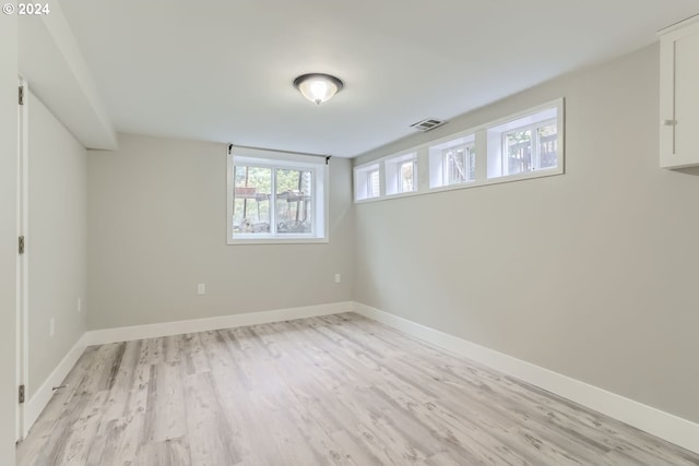 unfurnished room with light wood-type flooring