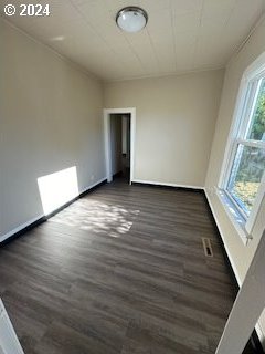 unfurnished room featuring dark hardwood / wood-style flooring