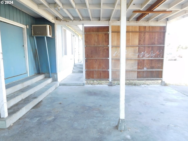 miscellaneous room with concrete floors and a wall mounted air conditioner