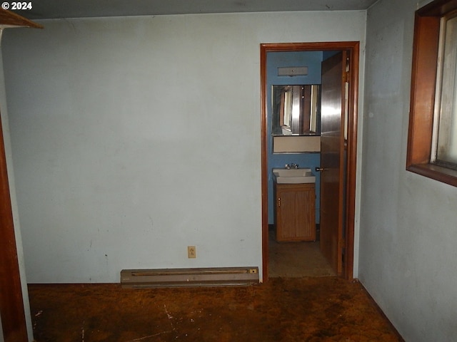 corridor featuring a baseboard heating unit and sink