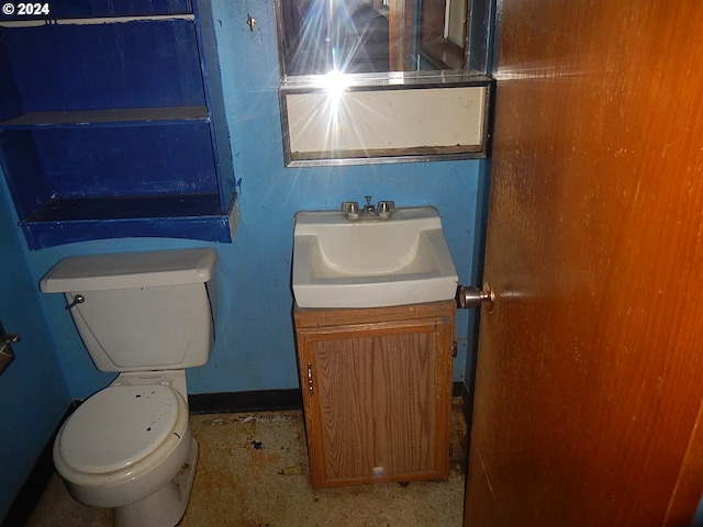 bathroom featuring toilet and vanity