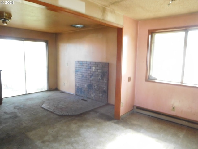 unfurnished living room featuring carpet floors and a baseboard radiator