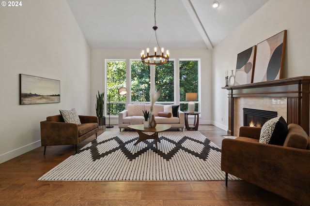 living room featuring a fireplace, vaulted ceiling, dark wood-type flooring, and a notable chandelier