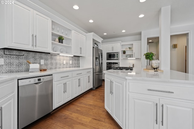 kitchen featuring white cabinetry, appliances with stainless steel finishes, dark hardwood / wood-style floors, and backsplash