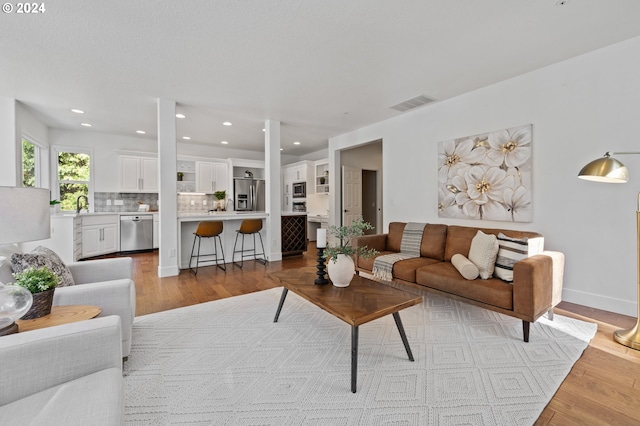 living room with light hardwood / wood-style flooring