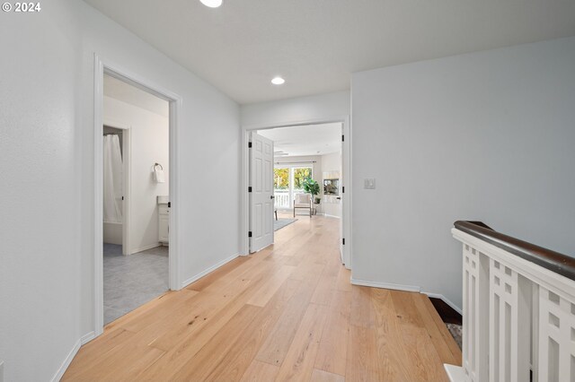 corridor with light wood-type flooring