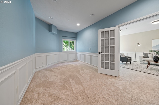 unfurnished room featuring light colored carpet