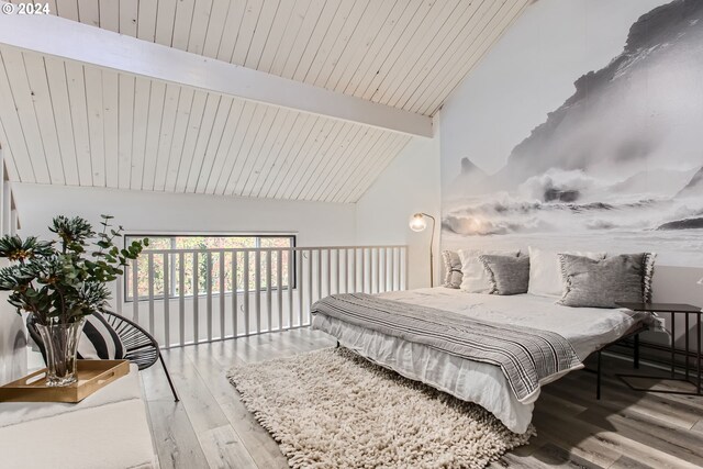 bedroom featuring a closet, high vaulted ceiling, beamed ceiling, and hardwood / wood-style floors