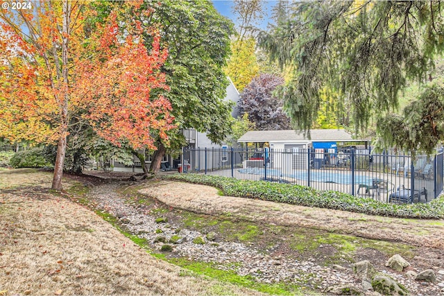 view of yard with a fenced in pool and a patio area