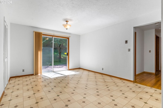 unfurnished room with a textured ceiling