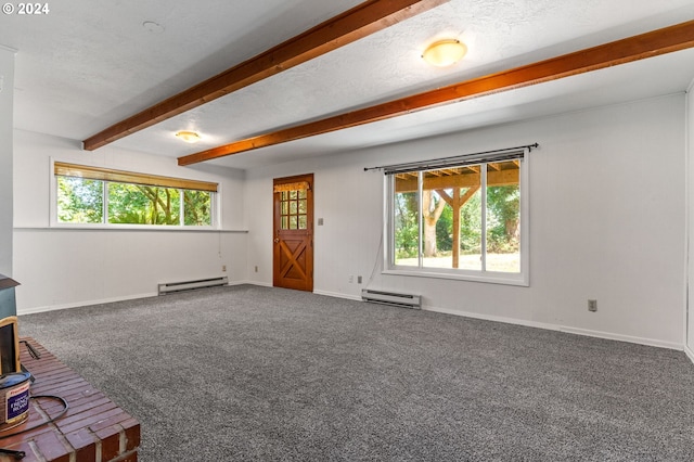 unfurnished living room with plenty of natural light, a wood stove, and a baseboard radiator