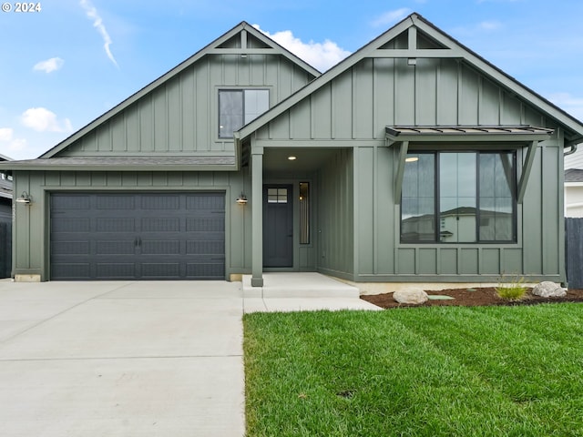 view of front of house with a front yard, board and batten siding, and driveway