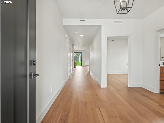 corridor featuring visible vents, recessed lighting, baseboards, and light wood-style floors