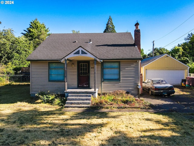 bungalow-style home featuring a garage and a front lawn