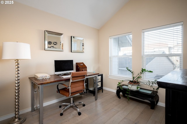 home office featuring vaulted ceiling and wood-type flooring