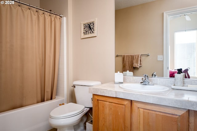 full bathroom with shower / bath combo with shower curtain, toilet, and vanity