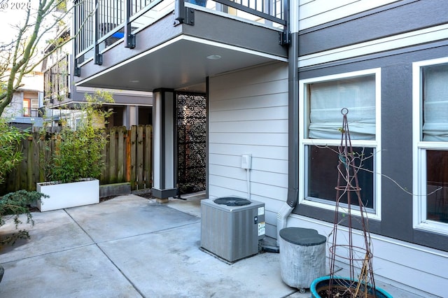 view of patio / terrace with central air condition unit and a balcony