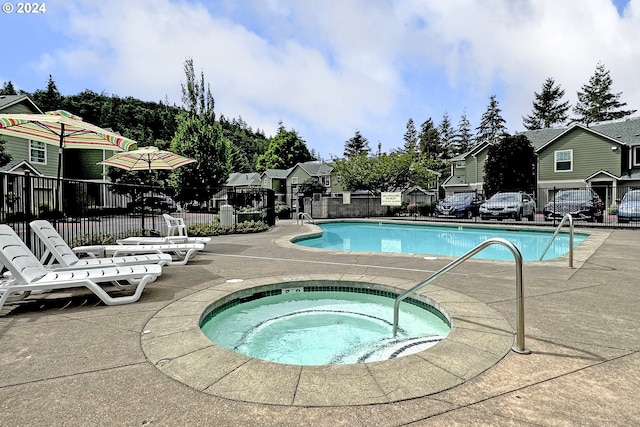 view of pool featuring a community hot tub and a patio