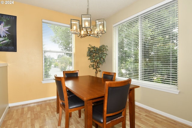 dining room featuring plenty of natural light, light hardwood / wood-style floors, and a notable chandelier