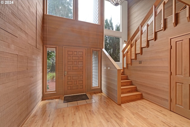 92932 Paschelke Rd, Marcola, OR 97454 - foyer entrance featuring wooden walls, stairway, a high ceiling, and wood finished floors