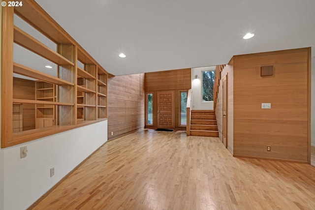 92932 Paschelke Rd, Marcola, OR 97454 - empty room featuring wooden walls, wood finished floors, recessed lighting, stairs, and baseboards