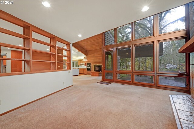 92932 Paschelke Rd, Marcola, OR 97454 - unfurnished living room featuring carpet flooring, recessed lighting, a glass covered fireplace, and baseboards