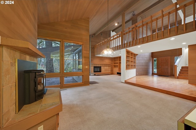 92932 Paschelke Rd, Marcola, OR 97454 - unfurnished living room featuring wood walls, a wood stove, carpet, high vaulted ceiling, and wood ceiling