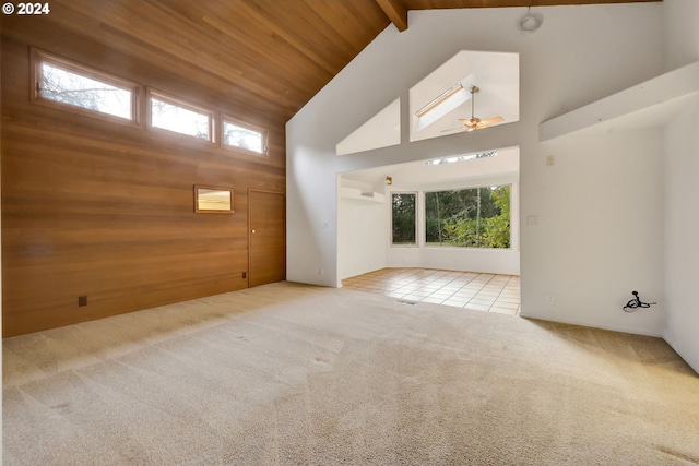 92932 Paschelke Rd, Marcola, OR 97454 - empty room with high vaulted ceiling, carpet flooring, wood walls, ceiling fan, and tile patterned floors