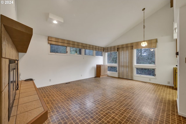 92932 Paschelke Rd, Marcola, OR 97454 - unfurnished living room with high vaulted ceiling, tile patterned floors, and baseboards