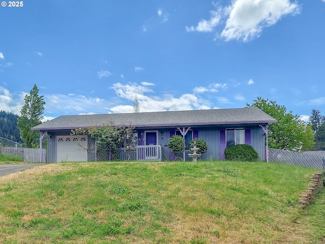 single story home with a garage and a front lawn