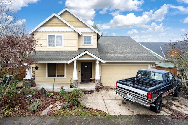 craftsman-style house featuring covered porch and a garage