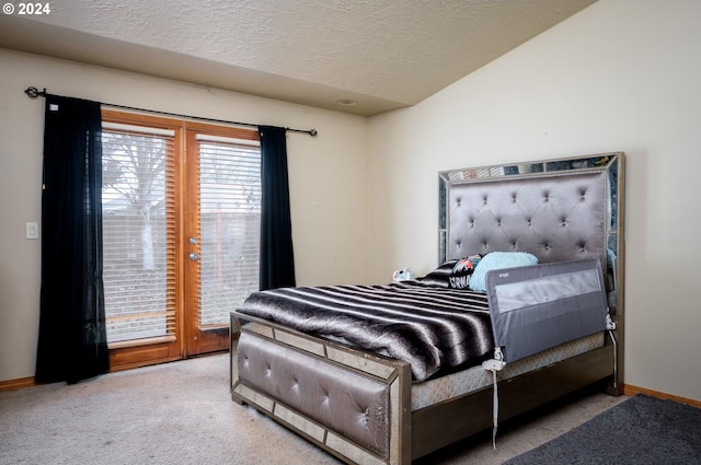 bedroom featuring carpet floors, a textured ceiling, and access to outside