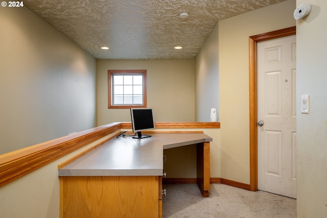 unfurnished office with light carpet and a textured ceiling