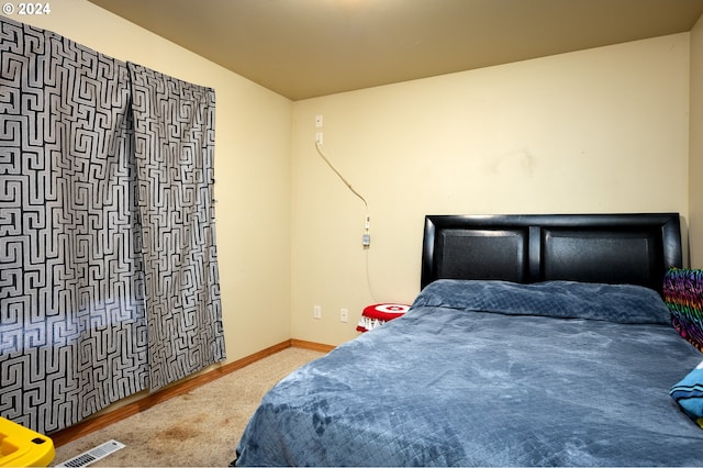 bedroom with wood-type flooring and lofted ceiling