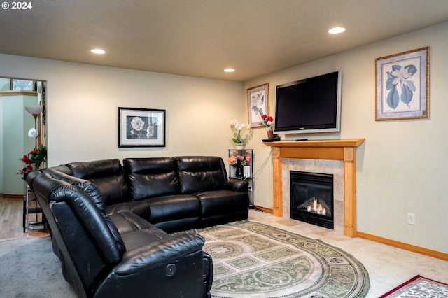 living room featuring carpet flooring and a tiled fireplace