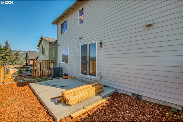 back of house with central air condition unit and a patio area