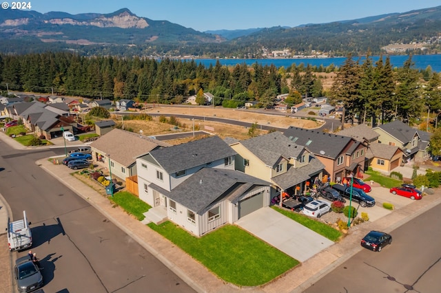 drone / aerial view with a water and mountain view