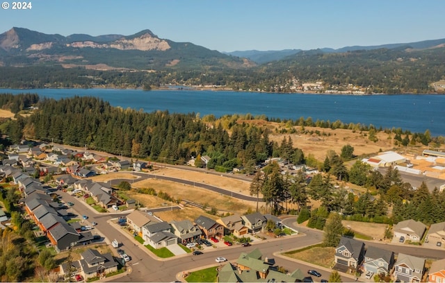 drone / aerial view with a water and mountain view