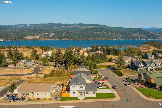 drone / aerial view with a water and mountain view