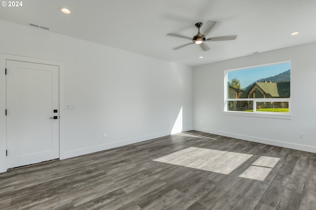 spare room featuring dark hardwood / wood-style floors and ceiling fan