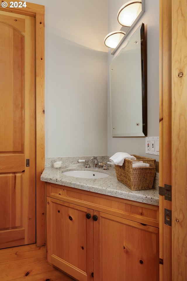 bathroom featuring vanity and wood finished floors