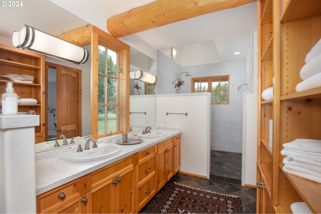 bathroom featuring a sink, a healthy amount of sunlight, and walk in shower