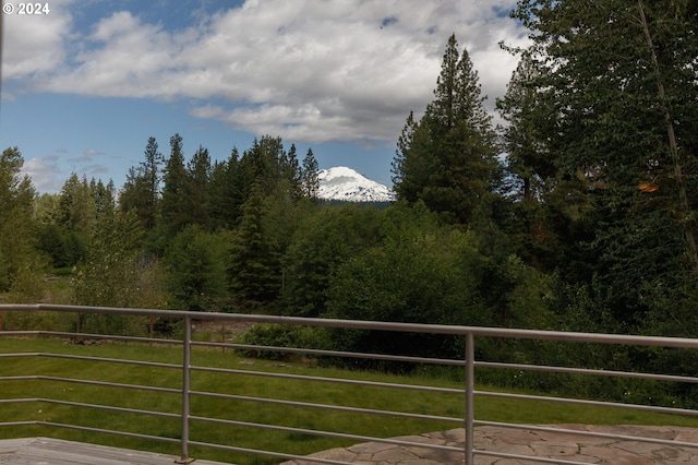 balcony featuring a mountain view and a wooded view