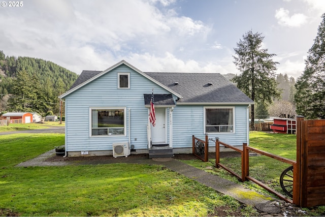 bungalow-style home with ac unit and a front lawn