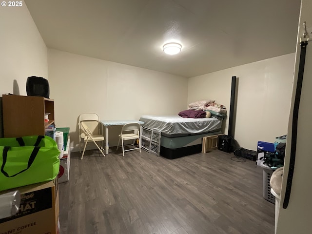 bedroom with dark wood-type flooring