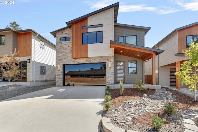 modern home featuring stone siding and concrete driveway